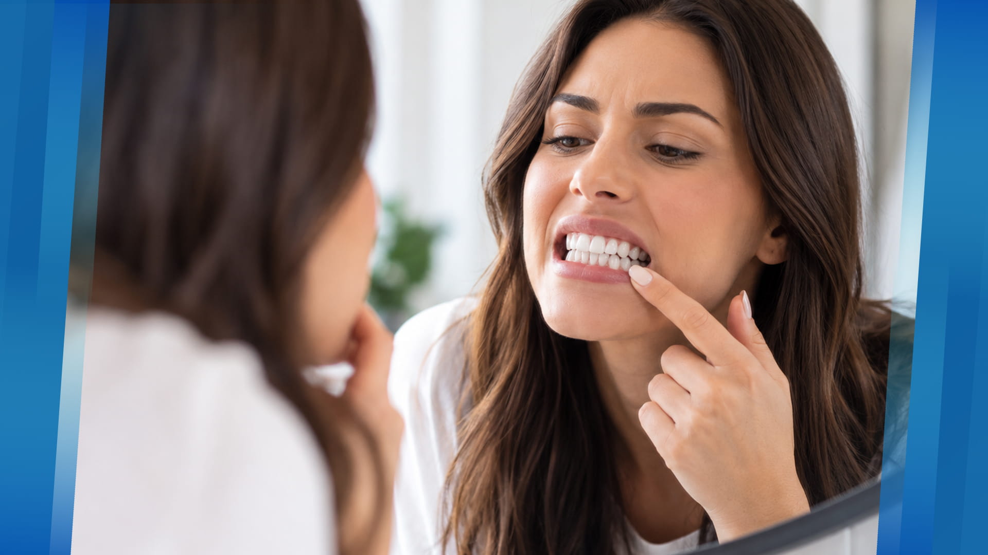 Woman checking her teeth in a mirror for early signs of tooth decay
